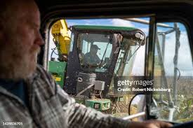 Farmer and landowner Robert Mack, left, drives a truck next to a... News  Photo