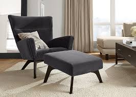 Coordinate a black sofa with the rest of the room by matching the pillows to the room, and displaying a colorful rug underneath the sofa. How To Find The Perfect Reading Chair Room Board