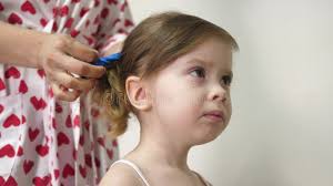 Mom Combs the Baby Hair and Collects it in a Ponytail