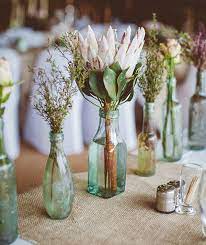 A Simple Idea For An Eco Wedding Recycled Glass Bottles As Stem Vases Wedding Flowers Wedding Centerpieces Wedding Decorations