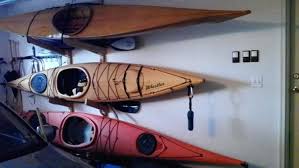 Swap the canoe with your vibrant colored kayak to splash color on a white ceiling. The Top Five Kayak Storage Ideas