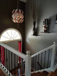 Split Level House Foyer Can Be Made To Be Beautiful Floating Bracketless Shelves With Dramatic Vases Entry Decor Foyer Decor Foyer Decorating