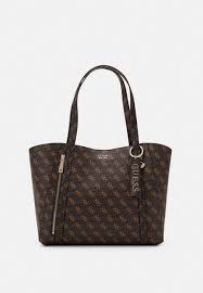 Guess's legacy acid and stonewash make an appearance, along with a variety of different patches and labels from previous decades. Guess Naya Tote Cabas Brown Marron Zalando Fr