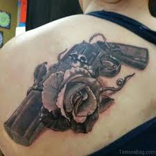 Skull put on the crossing of guns point and roses jointly done as her supreme chest piece. 64 Ultra Modern Gun Tattoos For Back