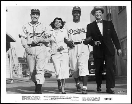 Film still from The Jackie Robinson Story showing (from left to right)  Richard Lane (as Clay Hopper), Ruby Dee (as Rachel Robinson), Jackie  Robinson (as himself), and Billy Wayne (as Clyde Sukeforth)