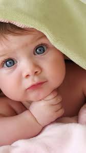 Portrait of sweet smiling newborn daughter lying on cozy bed. Baby Wallpaper Hd Images Allwallpaper