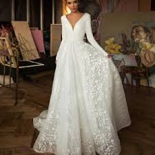 Gowns with long, fitted sleeves have been a favorite for centuries thanks to their versatility and elegance. Jasmine Empire Wholesale Wedding Dresses