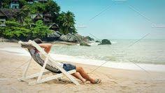 Young Man Relax In Beach Chair And Enjoy Seascape On Tropical Beach Beach Chairs Tropical Beach Beach