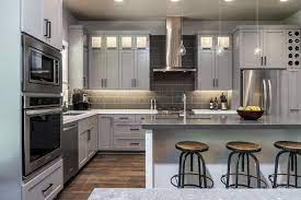 The light gray cabinets pictured in the coastal cool island getaway is the color of gray we will choose. Light Gray Cabinetry Complements White Island In Sleek Custom Kitchen Hgtv