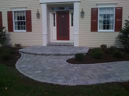 It's typically quite small and simple and often has a set of steps leading up to the front door. Stone Front Porch And Turning Walkway Landscape Authority Porch Landscaping Front Porch Landscape Stone Front Porch