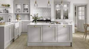 Grey green cabinets are perfect for kitchens that incorporate natural elements like tile, stone and wood. Chilcomb Dove Grey Kitchen Fitted Kitchens Howdens