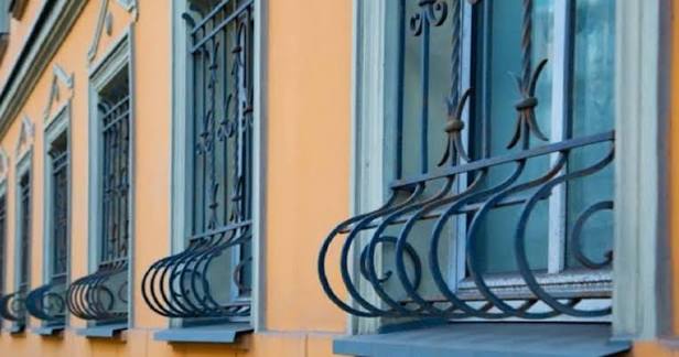 Why do some window grills curve at the bottom?