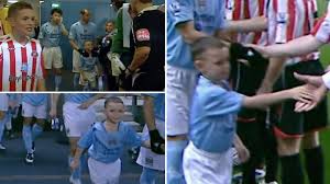 A huge team huddle, followed by backslaps and hugs all round. Footage Of A Young Phil Foden Walking Out At The Etihad Stadium As Manchester City Mascot Is Brilliant