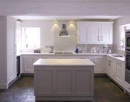 The warmth of the orange accents is tempered by the cool blue and brick tones. Farrow Ball Skimming Stone 241 Main Kitchen Farrow Ball Charleston Grey 243 Island Unit Trendy Kitchen Colors Kitchen Paint Kitchen Colors