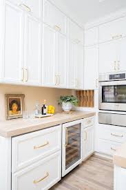 brass pulls on stacked white pantry