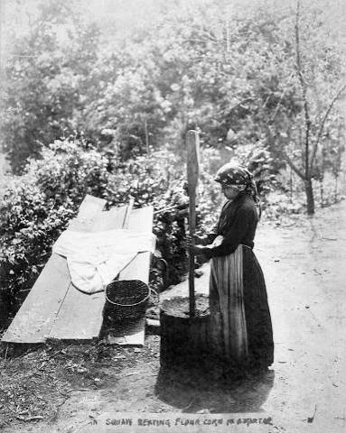 Woman pounding corn: Media item | NCpedia
