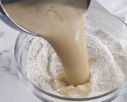 Image of Stirring flour and water into peanut butter mixture