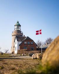The cross design, which represents christianity, was subsequently adopted by other nordic countries: A Lighthouse With A Danish Flag Danemark