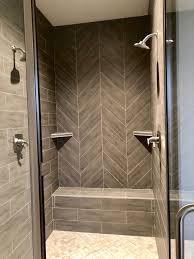 Custom Gray Herringbone Tiled Shower With Double Shower Heads And Bench Glass Doors Complete This Custom Walk In In 2020 Double Shower Heads Shower Tile Double Shower