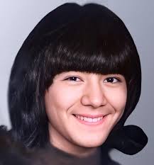 Please collect this photo of my sister. She has brown eyes and dark hair.