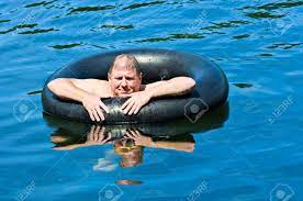 It's a good reason the days are. A Man In Water Floating On An Inner Tube Stock Photo Picture And Royalty Free Image Image 2900010