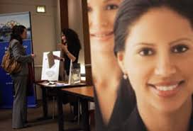 0466) Katie Flannery, of Denver, left, talks with Aimee Cohen, right, of  Cohen Career Consulting, at a free job fair put