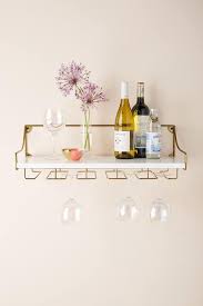 A wine rack isn't just practical storage. Mayfair Marble Brass Wall Mounted Wine Glass Shelf
