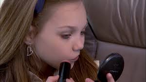 The moms help the girls get ready en route to their competition.