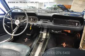 Interior original interior with roll bar, race harnesses, auto meter gauges in factory dash. 1966 Ford Mustang