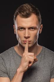 Man With Finger On His Mouth Stock Photos and Images
