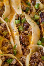 Philly Cheesesteak Stuffed Shells Made With Ground Beef Cheddar Bell Peppers And Onions With A Creamy Sauce To Dri Recipes Beef Recipes Stuffed Shells Recipe