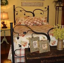 Glamorous wrought iron headboard in bedroom southwestern with wrought iron bed ideas next to terra cotta tile alongside corner headboard and exposed beam ceiling. Wrought Iron Bed As A Stylish And Functional Interior Element Small Design Ideas
