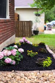 Rocks are available in an array of sizes, colors, and shapes, and creeping flowers look amazing tumbling over them! Front Yard Landscaping Ideas Our Simple Flower Bed Makeover