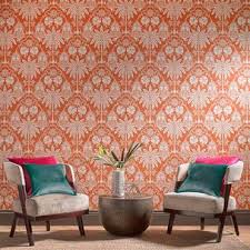 Chic pastel orange carpeted living room with light gray sofa, a fireplace, and stylish pillows. Imperial Orange Wallpaper Orange White Wallpaper