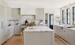 Wood and white cabinets with marble glass mosaic backsplash and granite countertops. Kitchen Renovation Part I The Identite Collective