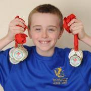Oliver Jones won 13 gold medals and a silver medal at the South East Wales  Swimming Championships