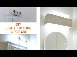 Camouflaging A Dated Off Center Bathroom Lighting Fixture I Needed A Quick Inexpensive Bathroom Lighting Bathroom Vanity Lighting Bathroom Remodel Small Diy