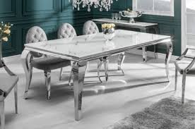 The table 'chained up miami' is an important dining table with structure in mirror polished stainless steel and top in calacatta marble, origin: Casa Padrino Designer Dining Table White Gray Silver 200 X 105 X H 75 Cm Rectangular Stainless Steel Kitchen Table With Digitally Printed Safety Glass In Marble Look Modern Baroque Furniture