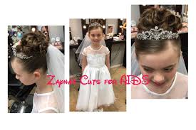 Although styling your daughter's hair on her first holy communion isn't as important as the ceremony, it still plays an integral part of the day. First Communion Hairstyle Updo Curls Veil Kids Hair Salon First Communion Hairstyles Communion Hairstyles