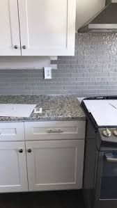 Santa Cecilia Light Granite Taupe Glass Backsplash White Cabinets White Modern Kitchen Light Gray Cabinets Glass Backsplash Kitchen