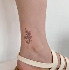 They not only represent beauty and grace but also represent hardship and struggles. Fine Line Flower Bouquet Tattoo On The Ankle