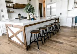 These cabinets and center island are matched well by the lighter backsplash and hood vent. Two Toned Island Two Toned Kitchen Island The Design Of The Kitchen Centered Aroun Farmhouse Kitchen Design Farmhouse Kitchen Decor Modern Farmhouse Kitchens