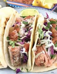 Layer each tortilla with a portion of salmon (use your fork to flake bite sized pieces off your roasted filet), slaw, and a generous dollop of guacamole. Simple Salmon Tacos With Slaw Salsa Heather Mangieri Nutrition