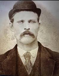 Is there any photos of him with a beard and mustache?