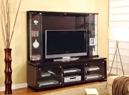 A Contemporary Entertainment Center In The Neutral Tones With Glass Display Wood Entertainment Center Entertainment Wall Units Entertainment Center Wall Unit