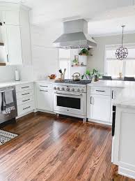 You need to know if the wall is load bearing or not. White Kitchen Remodel From Dark Cherry To Bright White