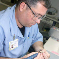 US Air Force (USAF) Major (MAJ) Jeff Eertmoed, Officer-in-Charge (OIC) and  Technical Sergeant (TSGT) Vicki Chacon, Pharmacy Technician, both with the  31st Medical Support Squadron (MSS), discuss a patients medication, inside  the
