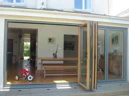 Sliding and folding door hardware. Bi Fold Doors Grey Exterior And Wood Interior Grey A Little Too Light But They Do A Nice Darker Petrol Blue Bifold Doors Modern House Plans House Exterior