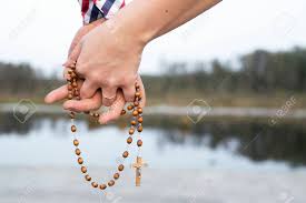 Group of people holding hands. Couple Pray Together Hands Holding Rosary Symbol Of Love To Stock Photo Picture And Royalty Free Image Image 142033360