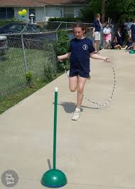 The first player on each team runs through an obstacle course, grabs a balloon, blows it up, ties a knot in it, then runs back through the course to the goal. Relays And Races